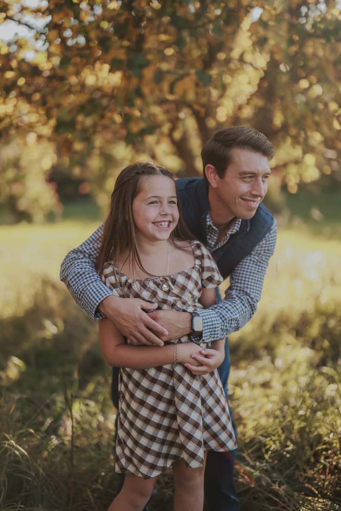 A father and daughter laughing together