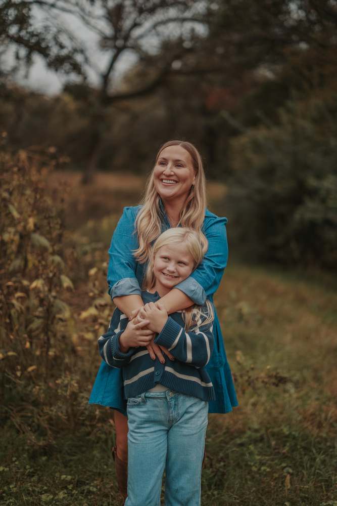A mother holding her daughter close