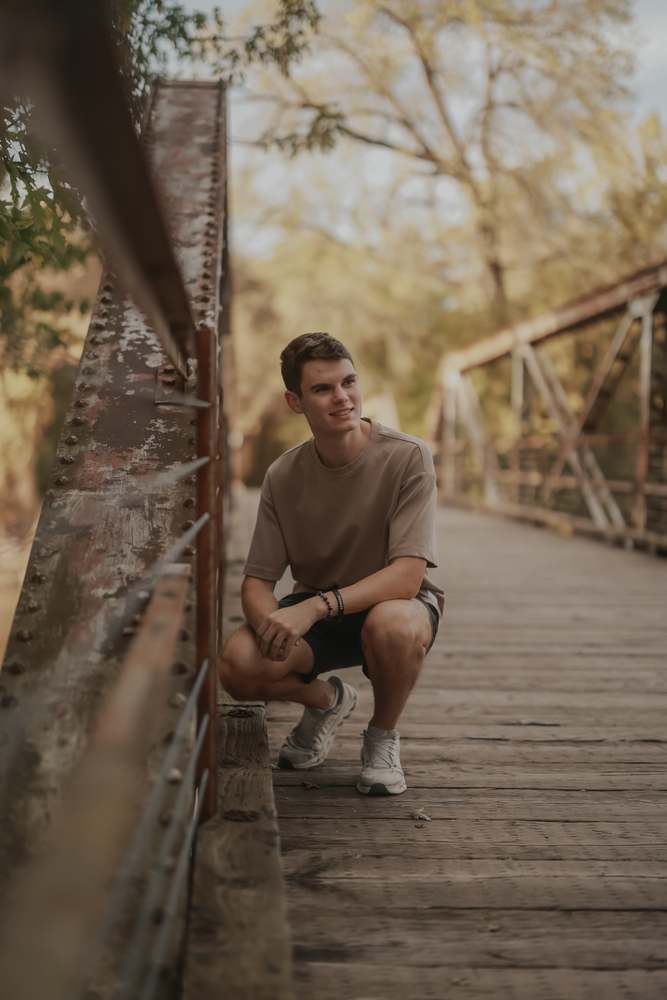 Crouched on the footbridge