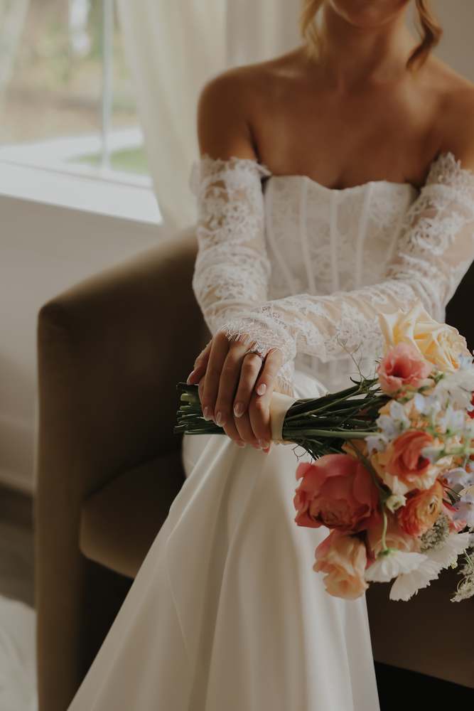 The bride with her peach and blue bouquet