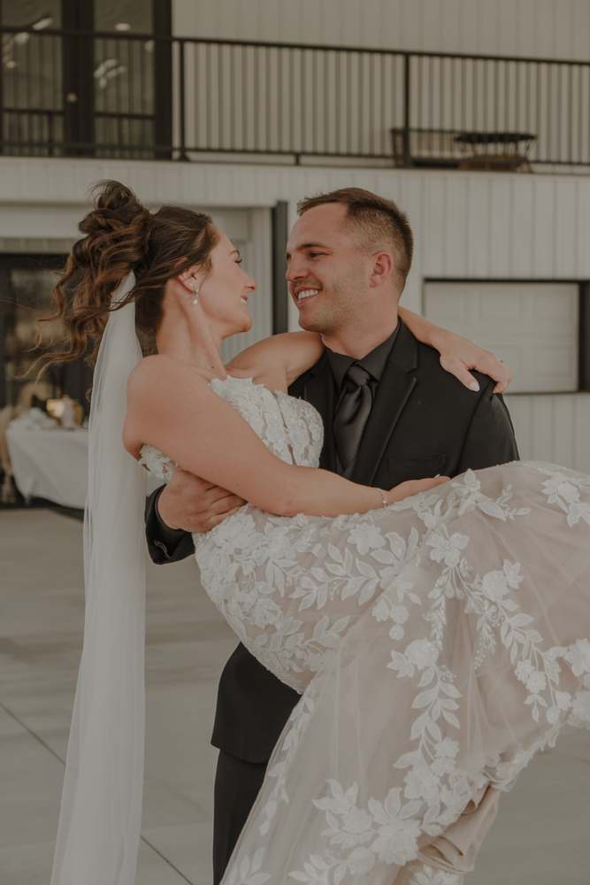 The groom lifting the bride off her feet
