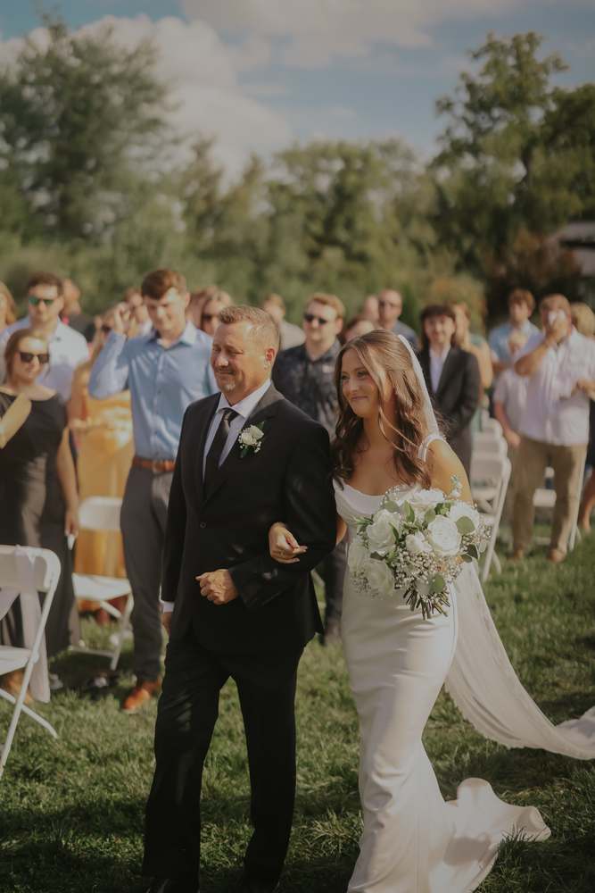 Escorted down the aisle through the guests
