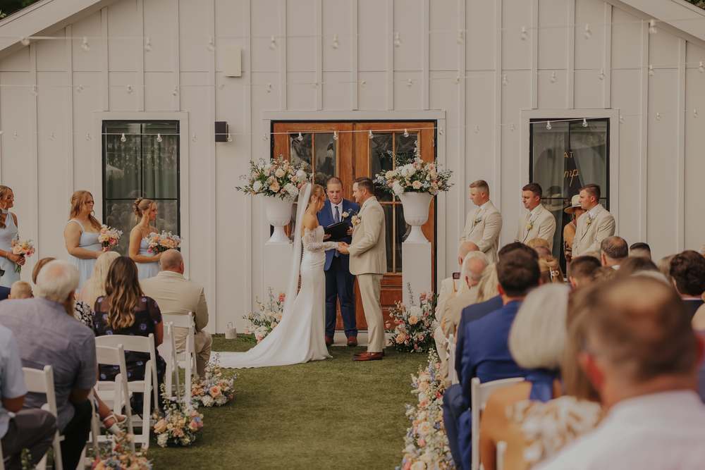 Exchanging vows in front of the white barn